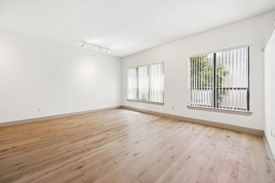 The bright, airy living boasts large windows that