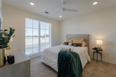 Bedroom featuring a ceiling fan, baseboards, carpet flooring, visible vents, and recessed lighting