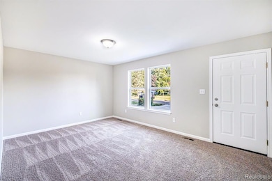 Empty room with baseboards and carpet flooring