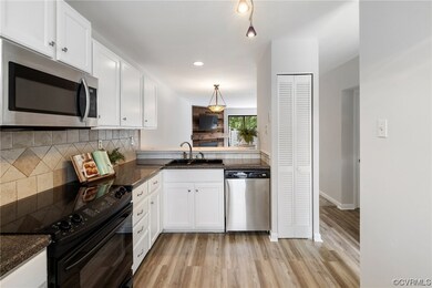 The updated kitchen has new LVP floors, stainless
