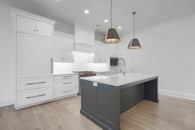 Fehrenbacher cabinetry, walk-in pantry, quartz countertops, high-end appliances, & spacious island.