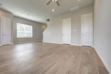Unfurnished room with a ceiling fan, light wood-s