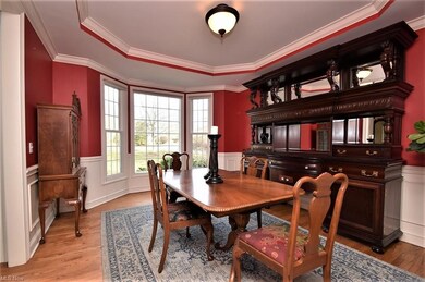 Dining Room with wood floors, crown moldings, tray