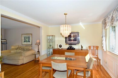 The formal dining room is complimented with pictur