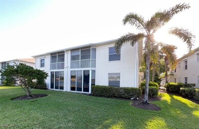 Back of property featuring a lawn and stucco sidin