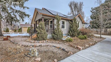 View of property exterior with solar panels, cover