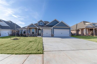 Craftsman-style home featuring covered porch, a ga