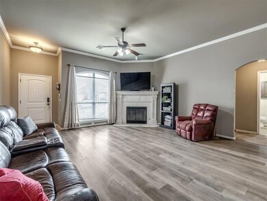 Living room with ceiling fan, ornamental molding, 