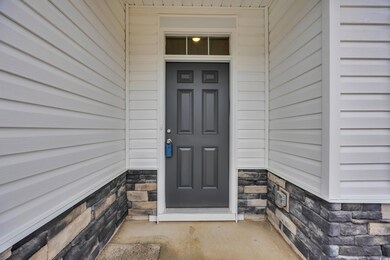 Doorway to property with stone siding