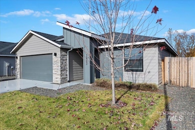 View of front of house featuring stone siding, a garage, and concrete driveway