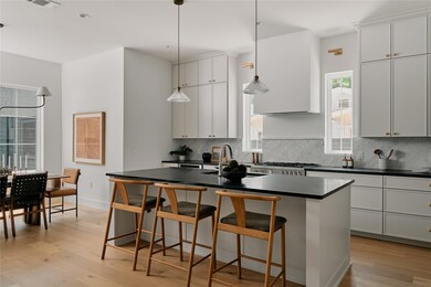 Kitchen featuring a sink, dark countertops, taste