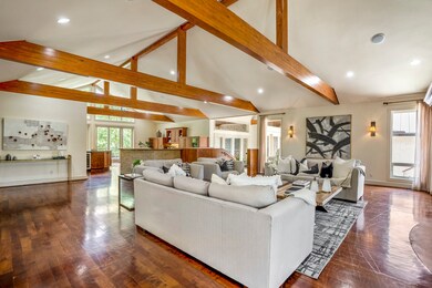 The living area includes high ceilings with expose