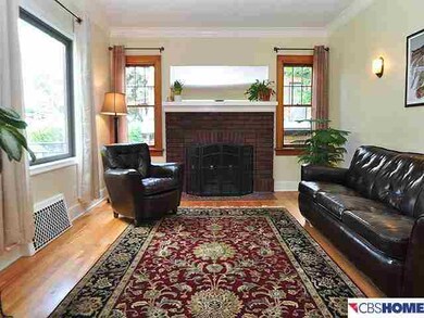 Light, Bright living room including a cozy brick fireplace with gas log.