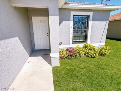 Property entrance featuring stucco siding and a la