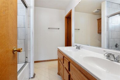 Bathroom with shower / bath combination with glass