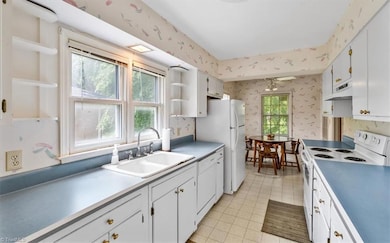 Charming galley kitchen filled with cabinets
