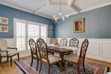 Formal dining room with hardwood floors, and custom moldings.
