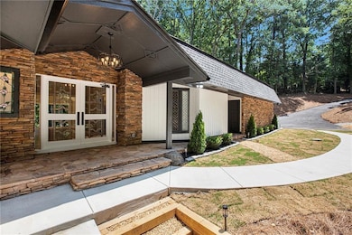 View of exterior entry with stone siding and french doors
