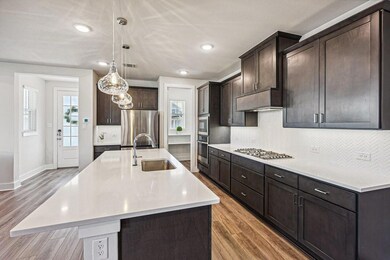 Kitchen with a kitchen island with sink, stainless