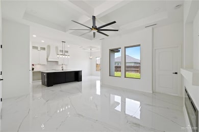 Unfurnished living room with coffered ceiling, recessed lighting, light marble finish flooring, beam ceiling, and a ceiling fan
