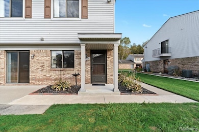 Property entrance with a lawn and brick siding