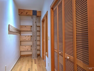 Corridor with wood finished floors and baseboards