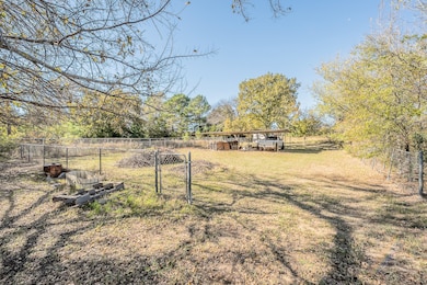 View of yard featuring an outbuilding and a gate