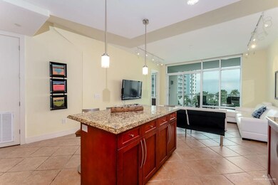 Kitchen with rail lighting, light tile patterned floors, visible vents, and dark brown cabinets