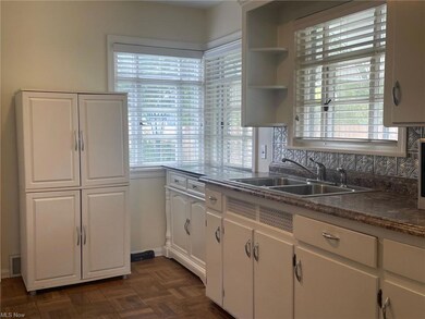Kitchen with stone look countertops dark, sink, ta