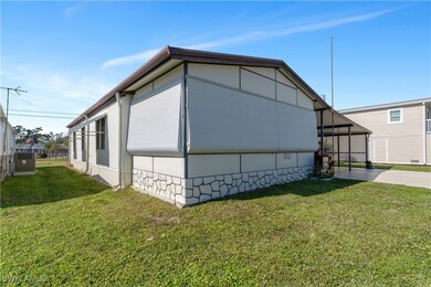 View of side of property featuring a lawn and a ca