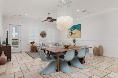 Dining area with stone tile flooring, a ceiling fan, crown molding, recessed lighting, and baseboards