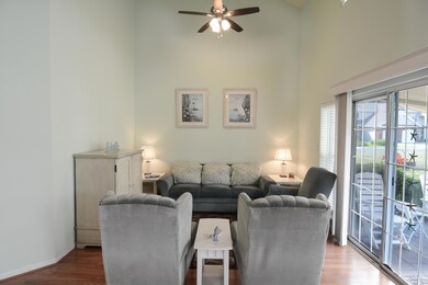 Living room featuring ceiling fan, wood-type floor