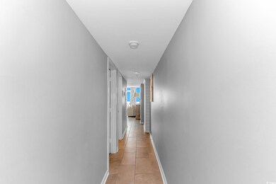 Corridor featuring light tile patterned floors