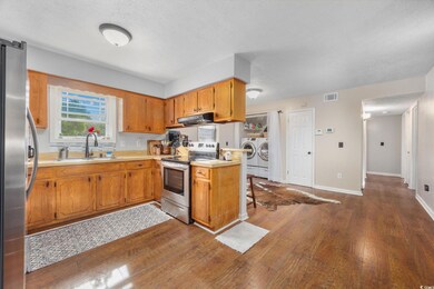 Kitchen with washing machine and clothes dryer, a 