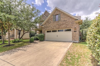 Traditional-style house with brick siding, drivew
