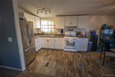 Kitchen with stainless steel fridge, white range w