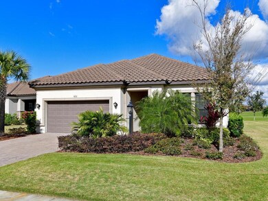Perfect home with a barrel tile roof, paver drivew