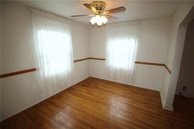 Two bright windows and a ceiling fan.