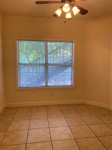 Spare room featuring light tile patterned floorin