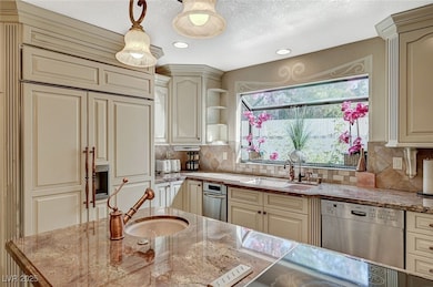 Kitchen featuring stainless steel dishwasher, crea