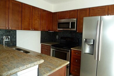 Granite breakfast bar and counters with tile floor