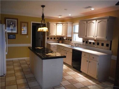 Tiled splash-backs and neutral Corian countertops.