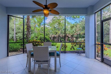 Sunroom featuring outdoor dining area, a ceiling fan, and view of scattered trees