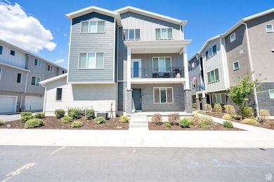 View of front of home featuring a balcony, board and batten siding, brick siding, and a residential view
