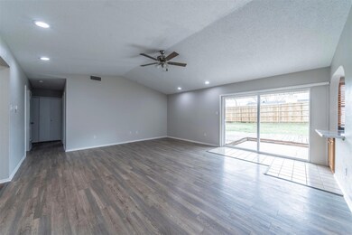 Unfurnished living room with dark wood-type floori