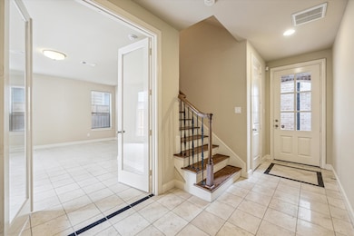 FOYER… Bright and inviting entryway has ceramic ti