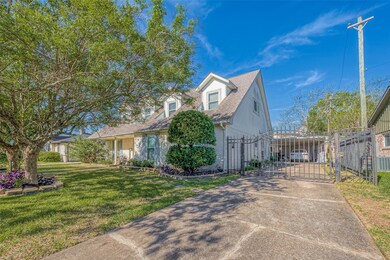 Automatic gate adds security to the home, which includes a detached, converted garage, a carport and fantastic backyard
