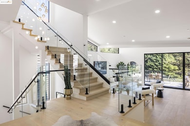Stairway with wood finished floors, plenty of natural light, and recessed lighting