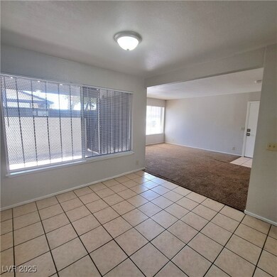Unfurnished room with light colored carpet, basebo