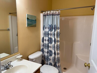Bathroom featuring a stall shower and vanity